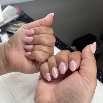 Glossy nude gel manicure with a soft almond shape