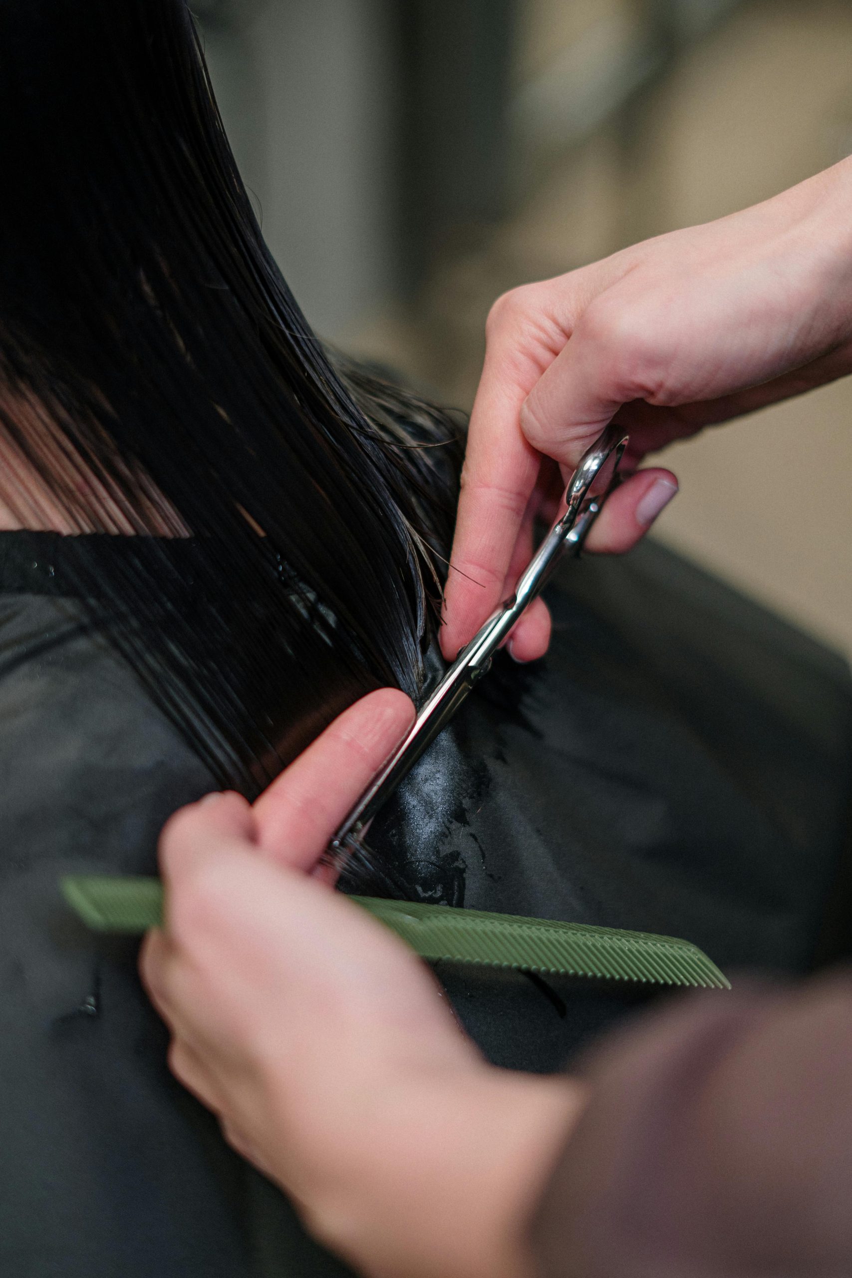 Stylist finishing a glossy blowout in the salon